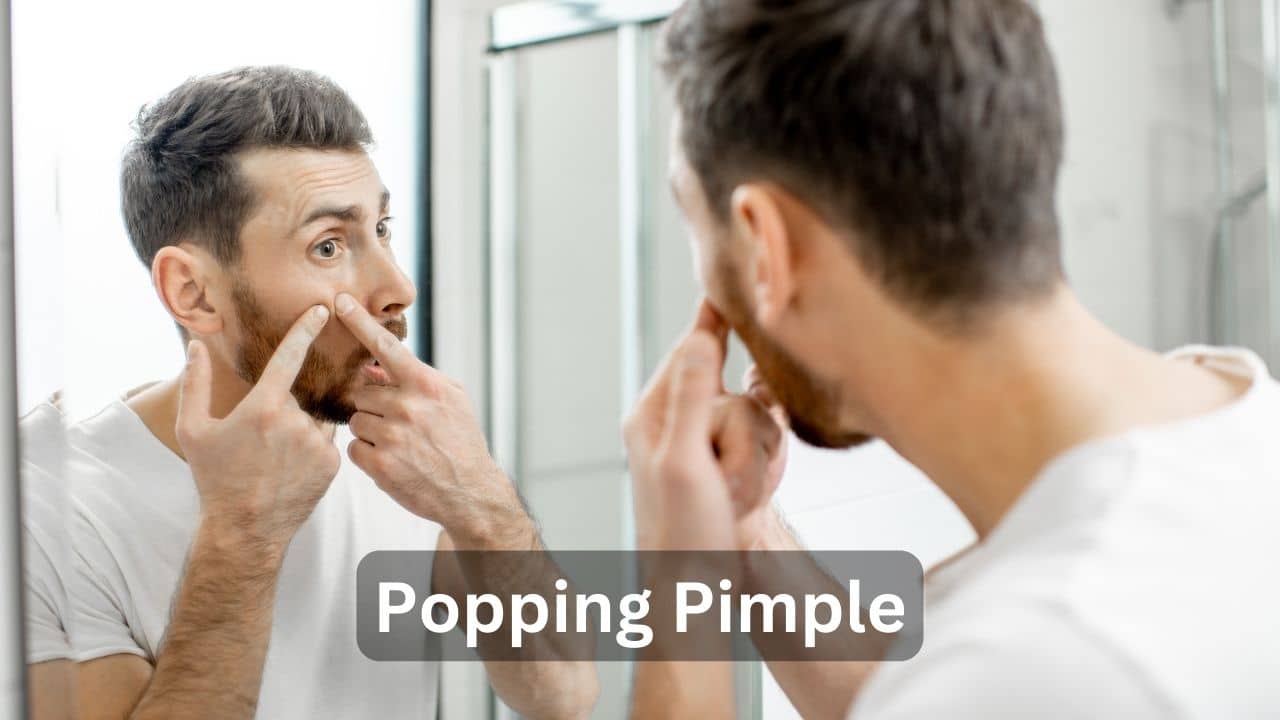 A man is popping his facial pimples